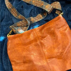 Elegant Tan Hobo Bag with Patterned Strap